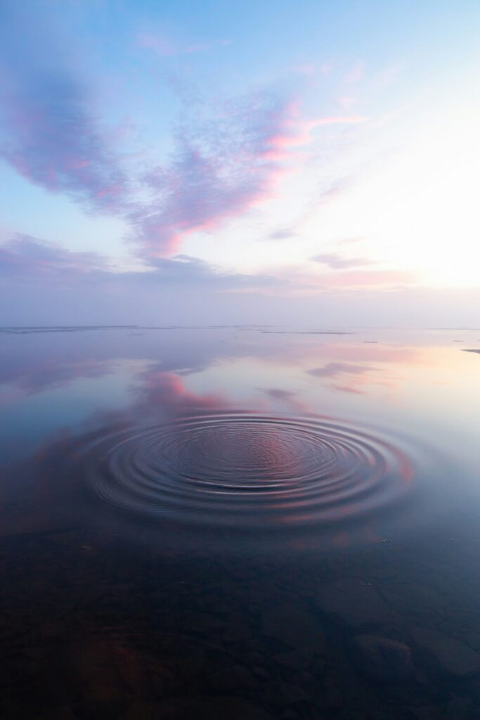 Water ripples spreading across calm lake symbolizing the ripple effect of kindness