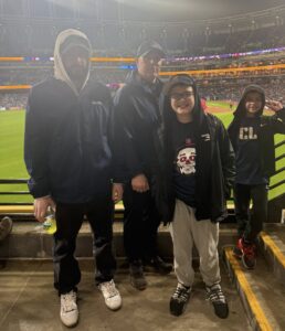 Father with his sons at a Cleveland Guardians game reflecting fatherhood, masculinity, and emotional connection