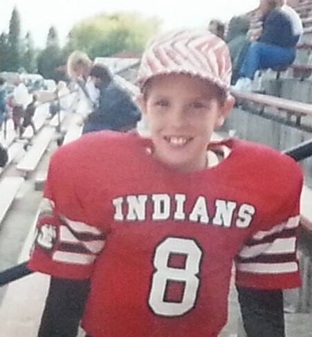 Childhood football photo from youth sports reflecting masculinity and emotional vulnerability in men