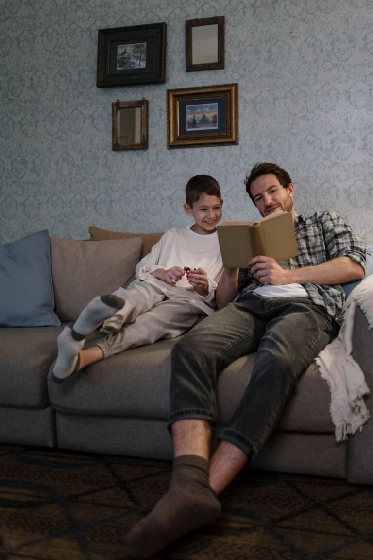 Father reading with his son while sharing one of the ordinary moments that become life's greatest memories.