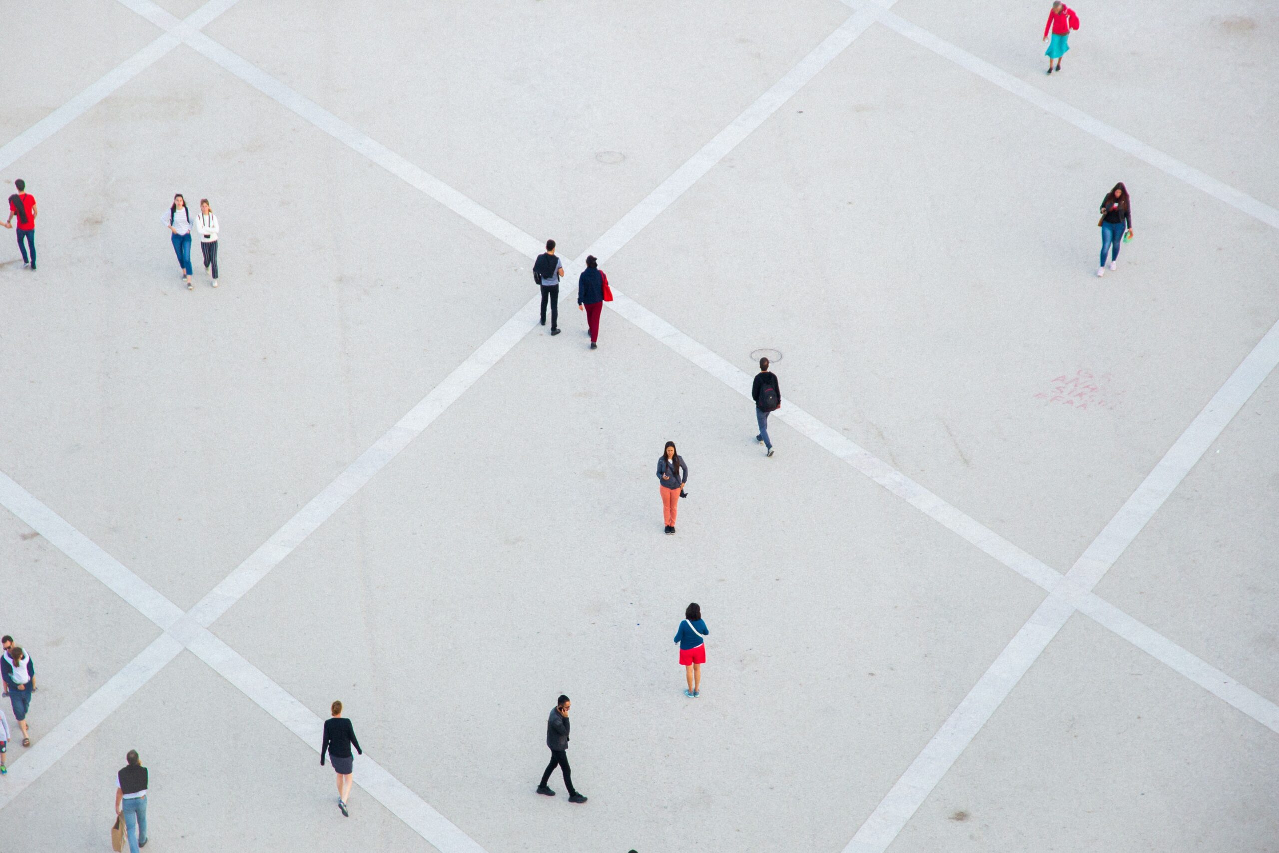People walking in different directions from above or Crowd of people walking through a city plaza